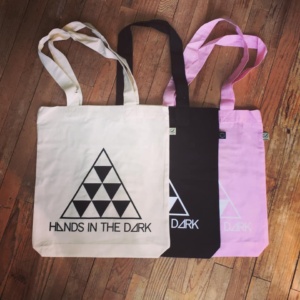 Totebag logo design Hands in the dark